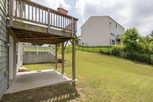 a view of a house with backyard porch and sitting area