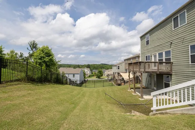a view of a house with a wooden fence