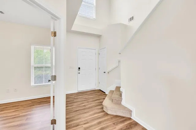 a view of an empty room with window and fireplace