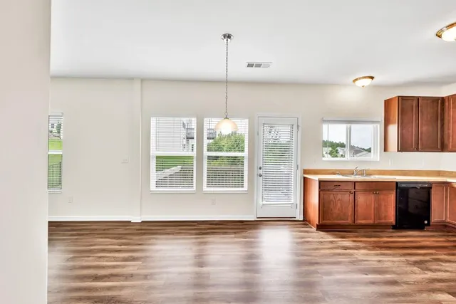 a kitchen with stainless steel appliances granite countertop a stove and cabinets