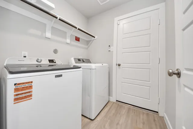 a utility room with closet dryer and washer