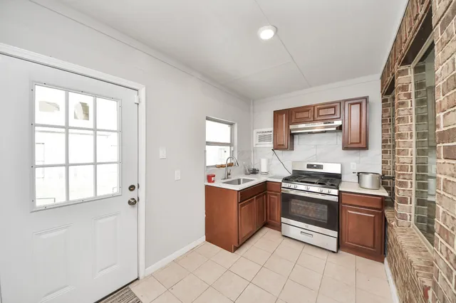 a kitchen with stainless steel appliances granite countertop a stove and a sink