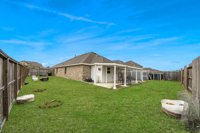 a view of a house with a yard table and chairs