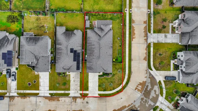 an aerial view of residential houses with outdoor space and swimming pool