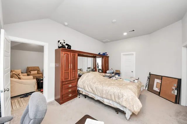 a bedroom with a bed and a dresser
