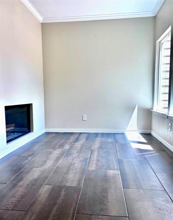 5616 Preston Oaks Road, Unit 1605 Dallas, TX 75254 - Photo 3 of 18 Enjoy this flexible space just inside the front door. Highlighted by a double-sided fireplace and updated flooring. This space would make a great study or play space.