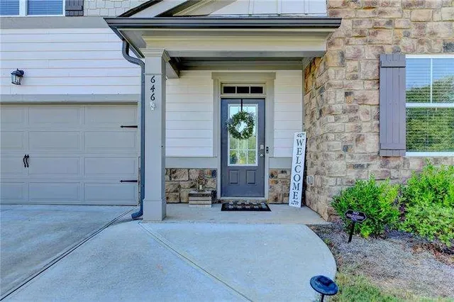 a view of a room with wooden floor and windows