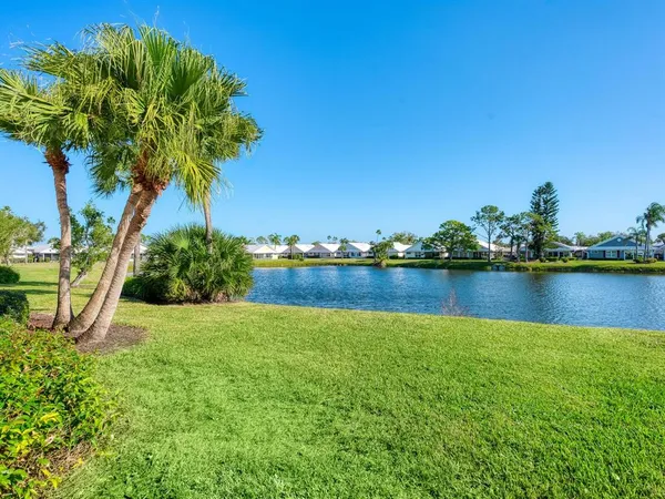a view of a lake with a house in the background