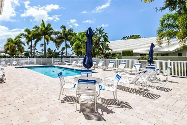 a view of a swimming pool with lounge chairs