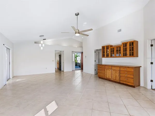 a view of a livingroom with a ceiling fan and window