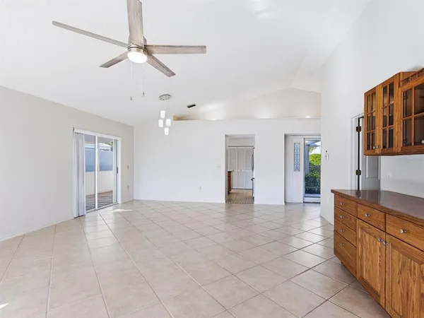 a view of a kitchen with furniture and a chandelier fan
