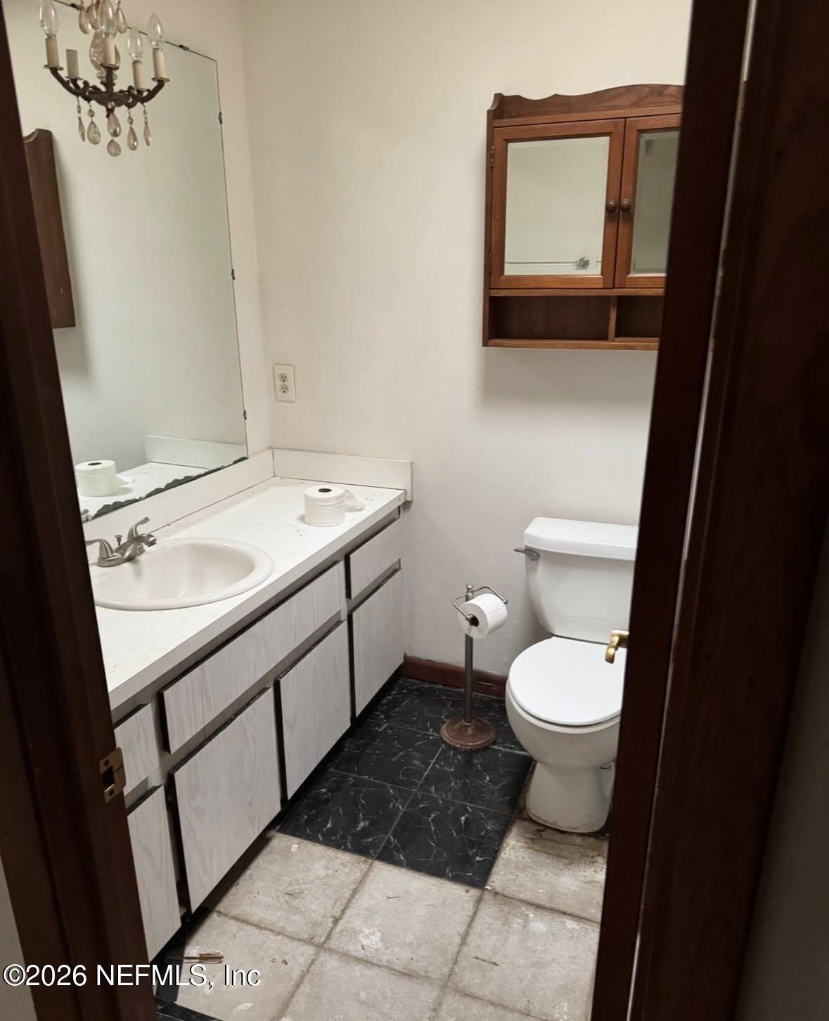 943 Noah Road Jacksonville, FL 32218 - Photo 4 of 7 a bathroom with a toilet sink and mirror