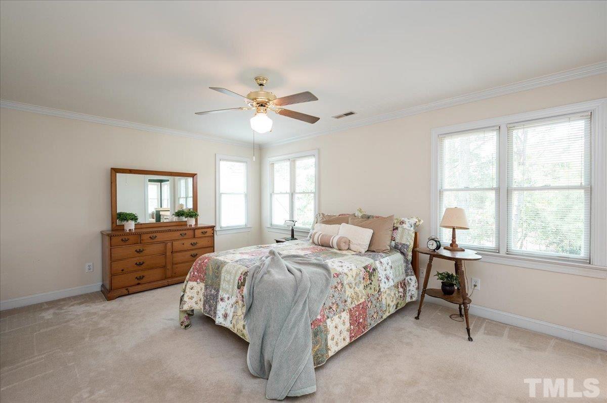 8813 Cottingham Way Raleigh, NC 27615 - Photo 14 of 27 a bedroom with a bed and a window