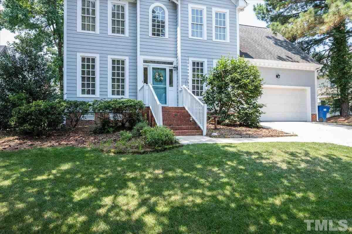 8813 Cottingham Way Raleigh, NC 27615 - Photo 22 of 27 a front view of a house with a yard and garage