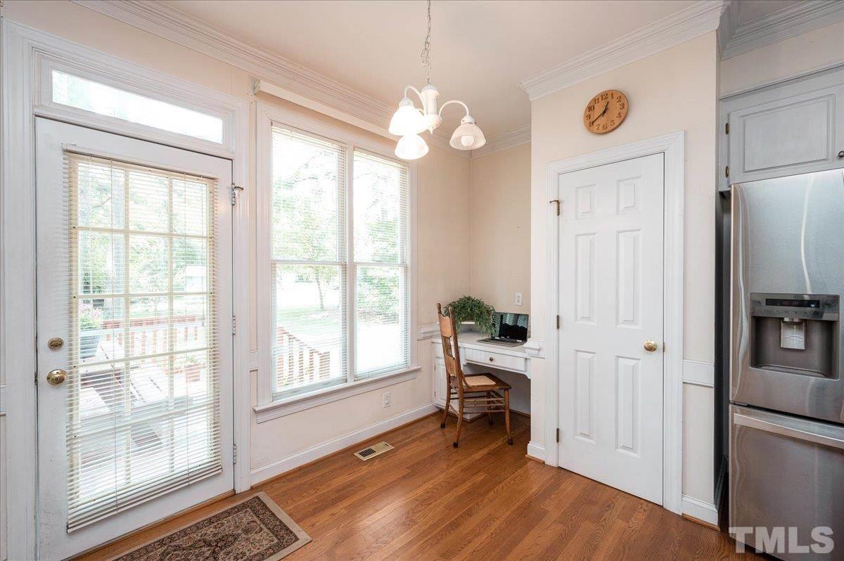 8813 Cottingham Way Raleigh, NC 27615 - Photo 9 of 27 a view of an empty room with a window and wooden floor