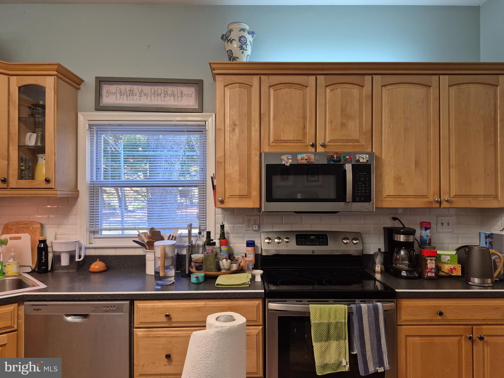 12512 Ofallon Street Silver Spring, MD 20904 - Photo 12 of 44 a kitchen with stainless steel appliances granite countertop a stove a sink and a microwave