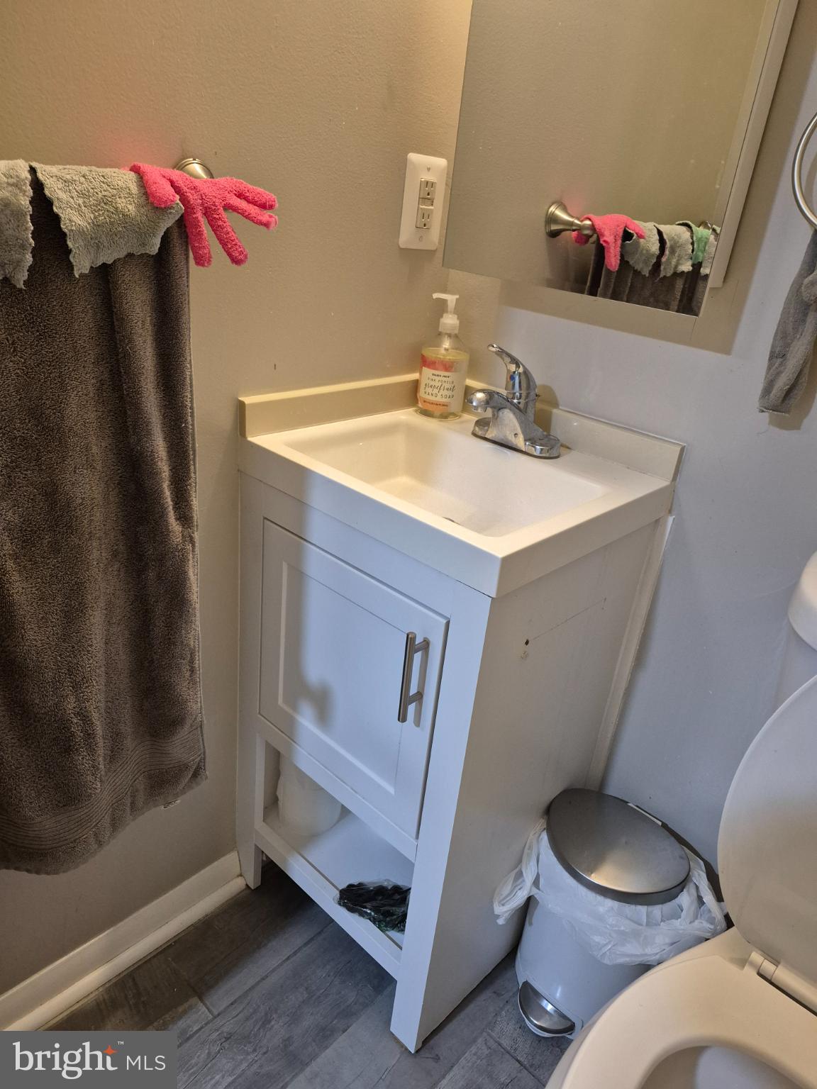 12512 Ofallon Street Silver Spring, MD 20904 - Photo 40 of 44 a bathroom with a sink mirror vanity and toilet