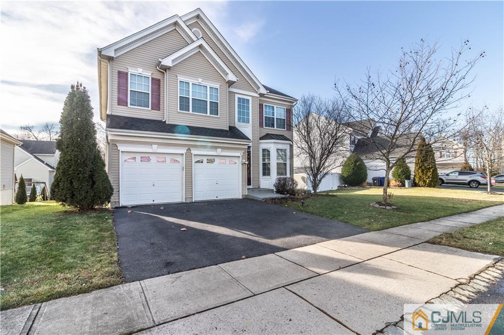 4 Seneca Lane Bordentown, NJ 08505 - Photo 2 of 29 a front view of a house with a yard and garage