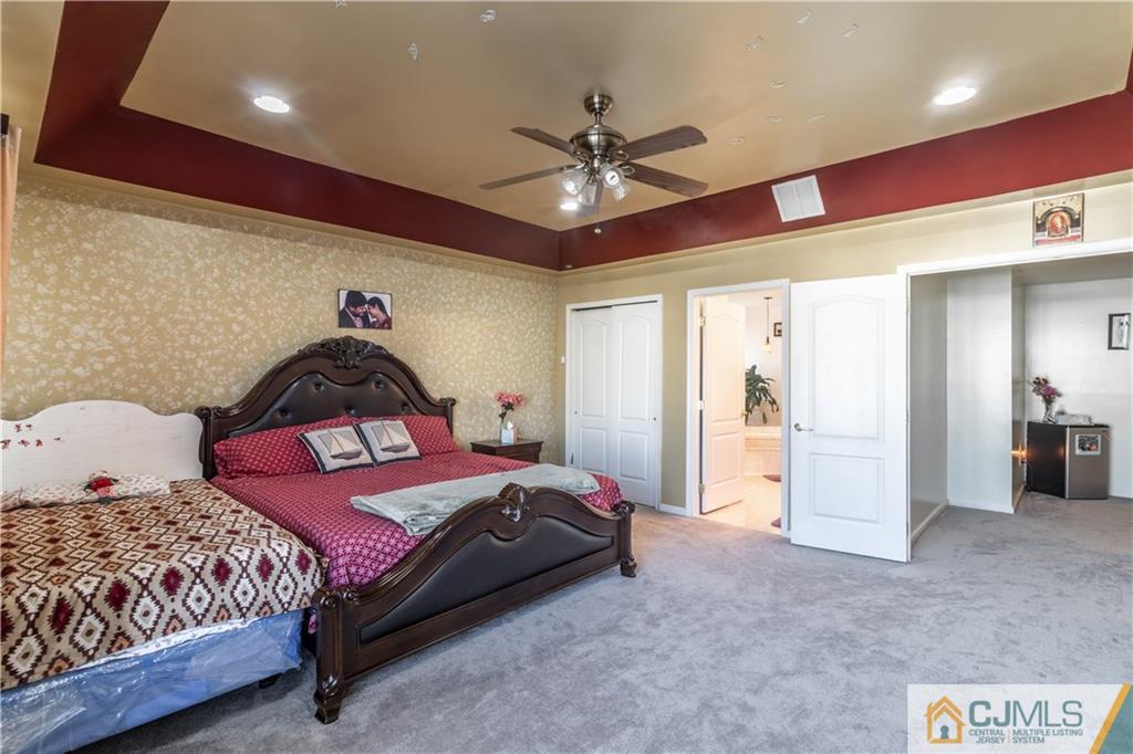 4 Seneca Lane Bordentown, NJ 08505 - Photo 12 of 29 a bedroom with a bed and a chandelier