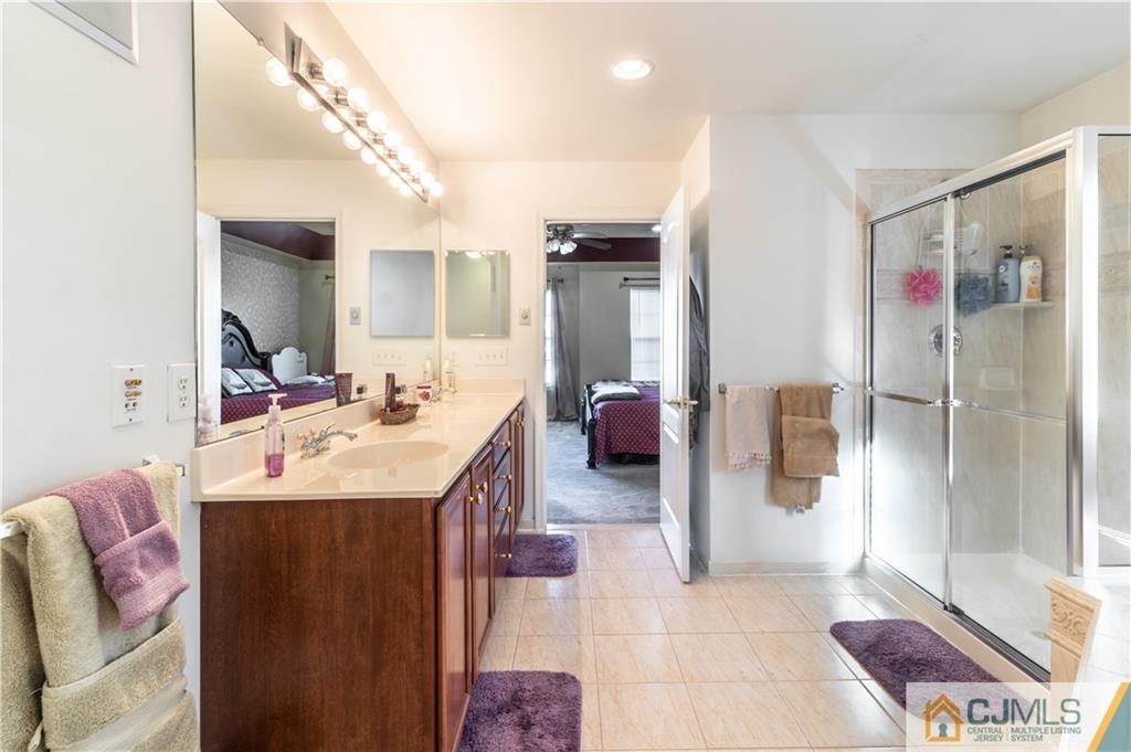 4 Seneca Lane Bordentown, NJ 08505 - Photo 14 of 29 a en suite bathroom with a sink a mirror and a shower