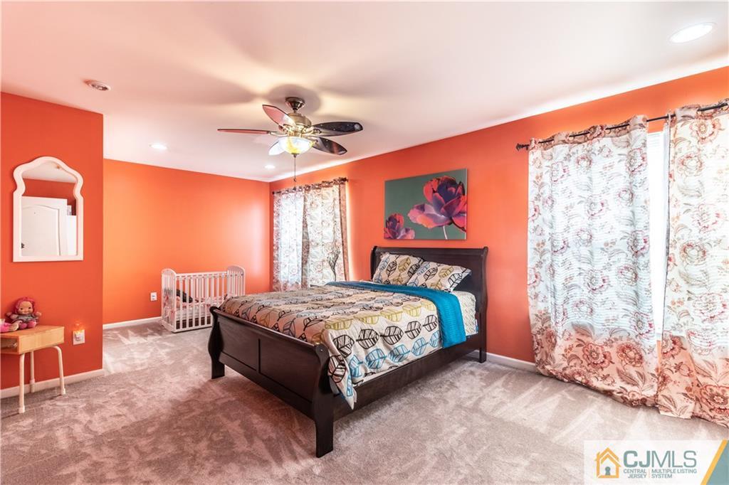 4 Seneca Lane Bordentown, NJ 08505 - Photo 16 of 29 a bedroom with a bed and a chandelier