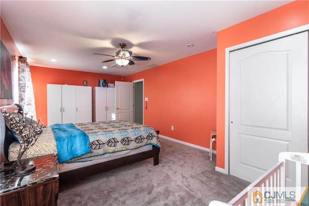 4 Seneca Lane Bordentown, NJ 08505 - Photo 17 of 29 a bedroom with a bed and a chandelier