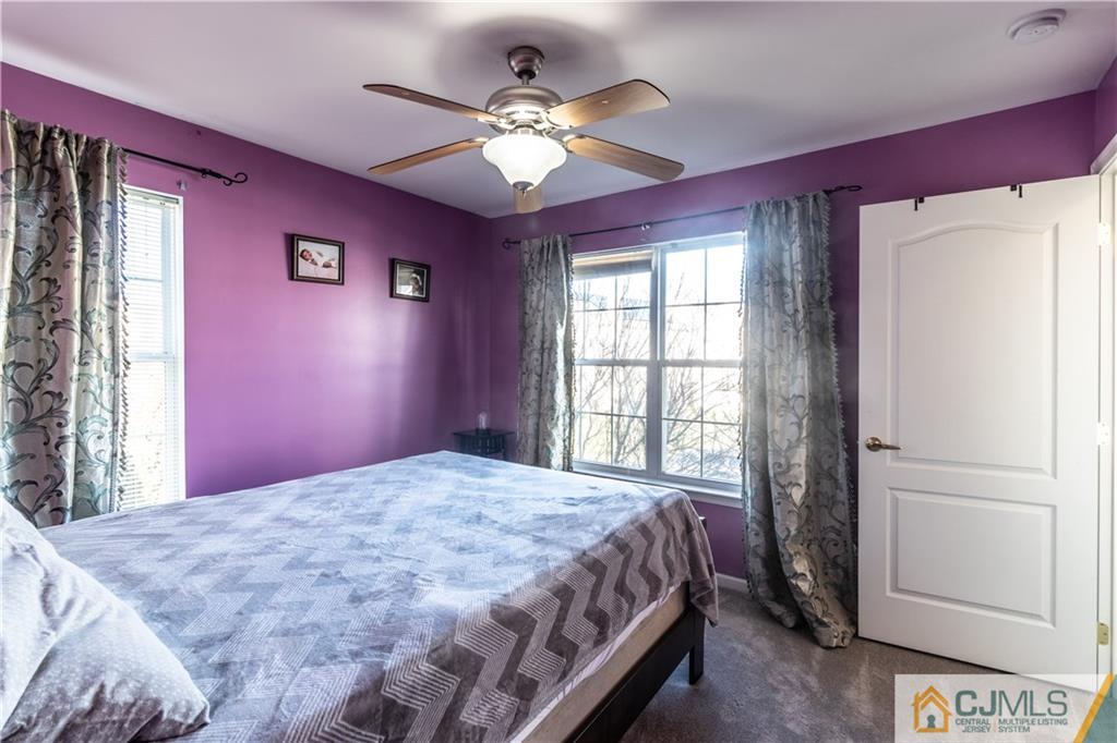 4 Seneca Lane Bordentown, NJ 08505 - Photo 19 of 29 a bedroom with a large bed and a chandelier