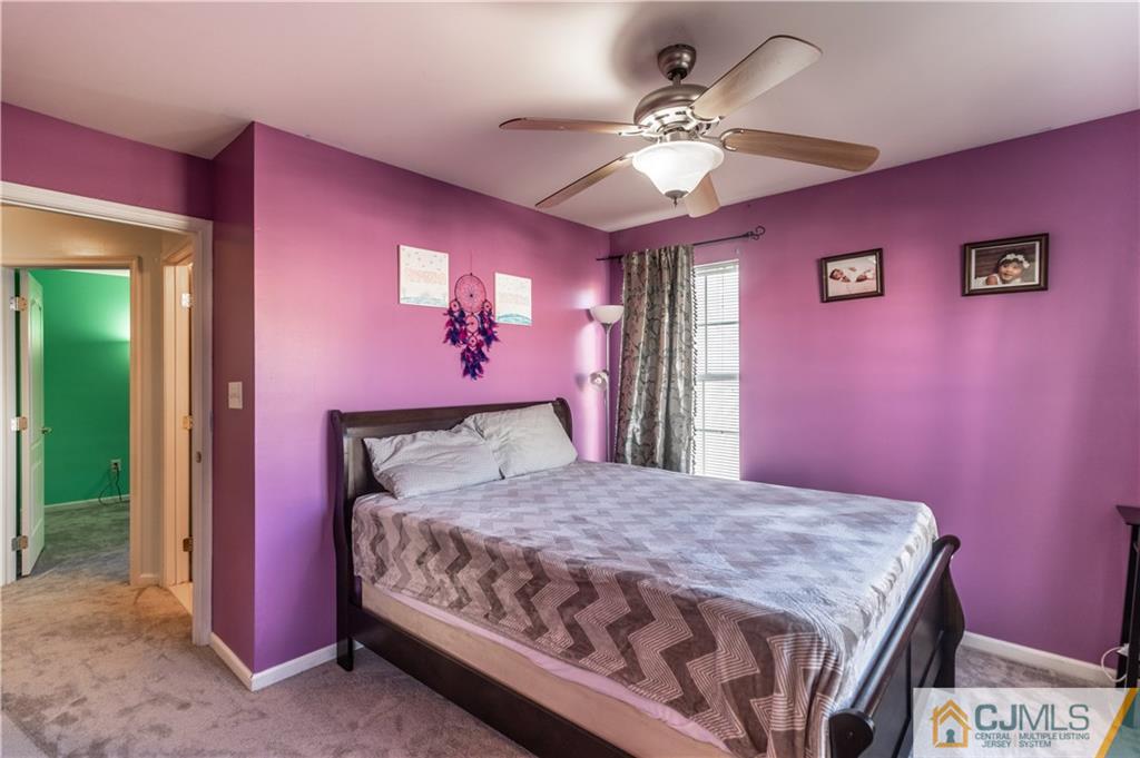 4 Seneca Lane Bordentown, NJ 08505 - Photo 20 of 29 a bedroom with a large bed and a chandelier