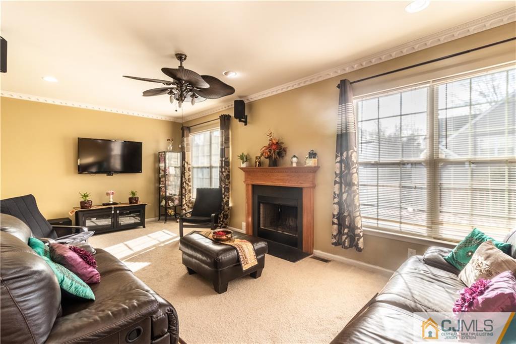 4 Seneca Lane Bordentown, NJ 08505 - Photo 6 of 29 a living room with furniture a flat screen tv and a fireplace