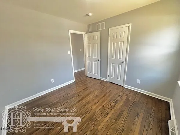 a view of a room with wooden floor