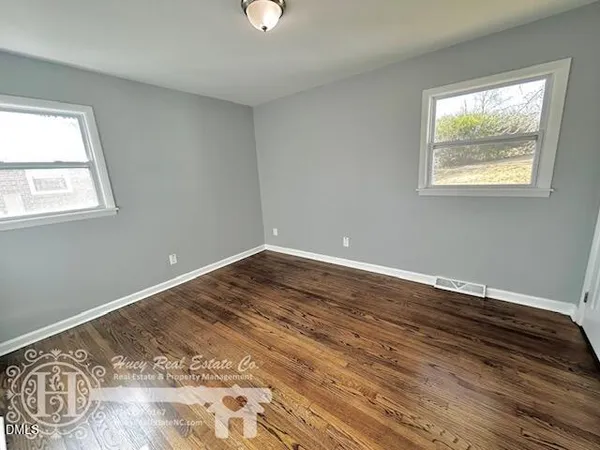 a view of a room with wooden floor and window