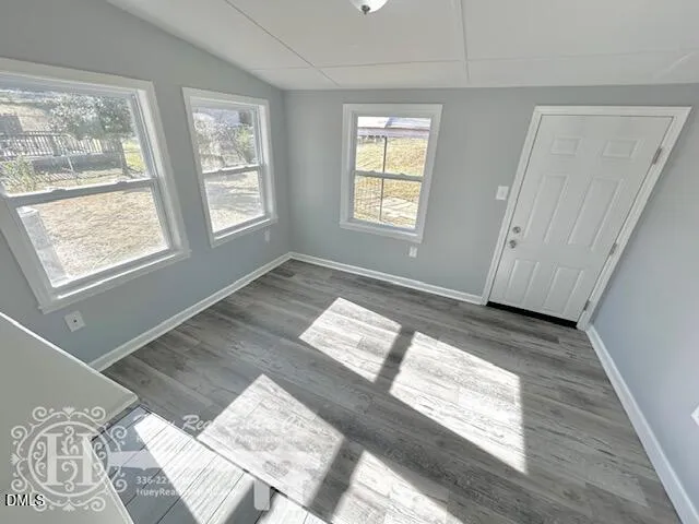 a view of wooden floor and windows in a room