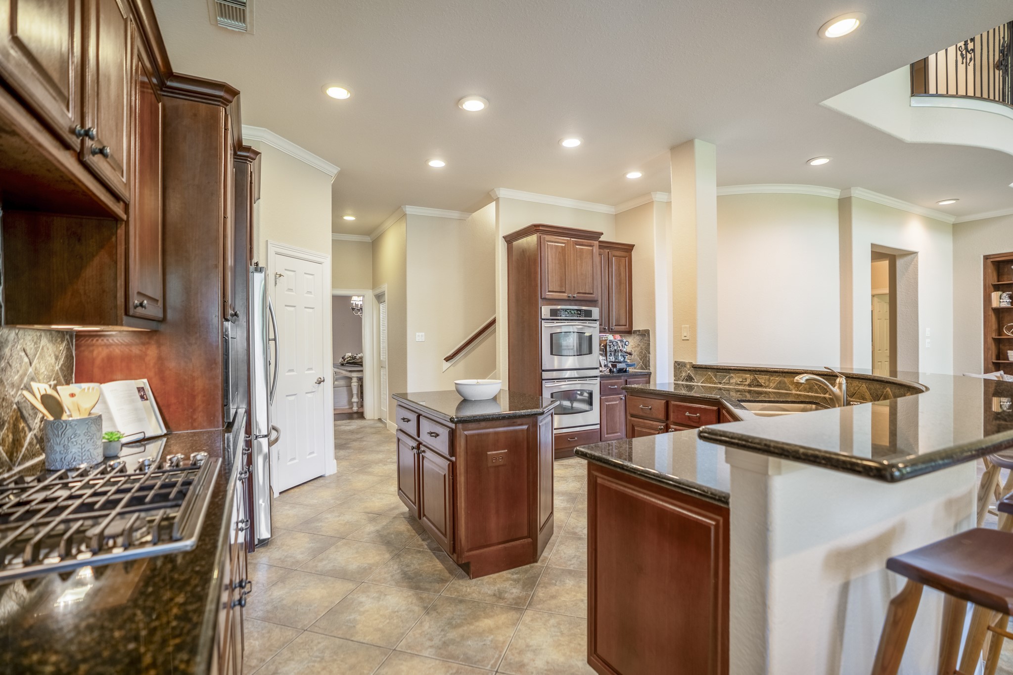 67 North Pentenwell Circle Spring, TX 77382 - Photo 12 of 50 a kitchen with stainless steel appliances granite countertop a stove and a sink