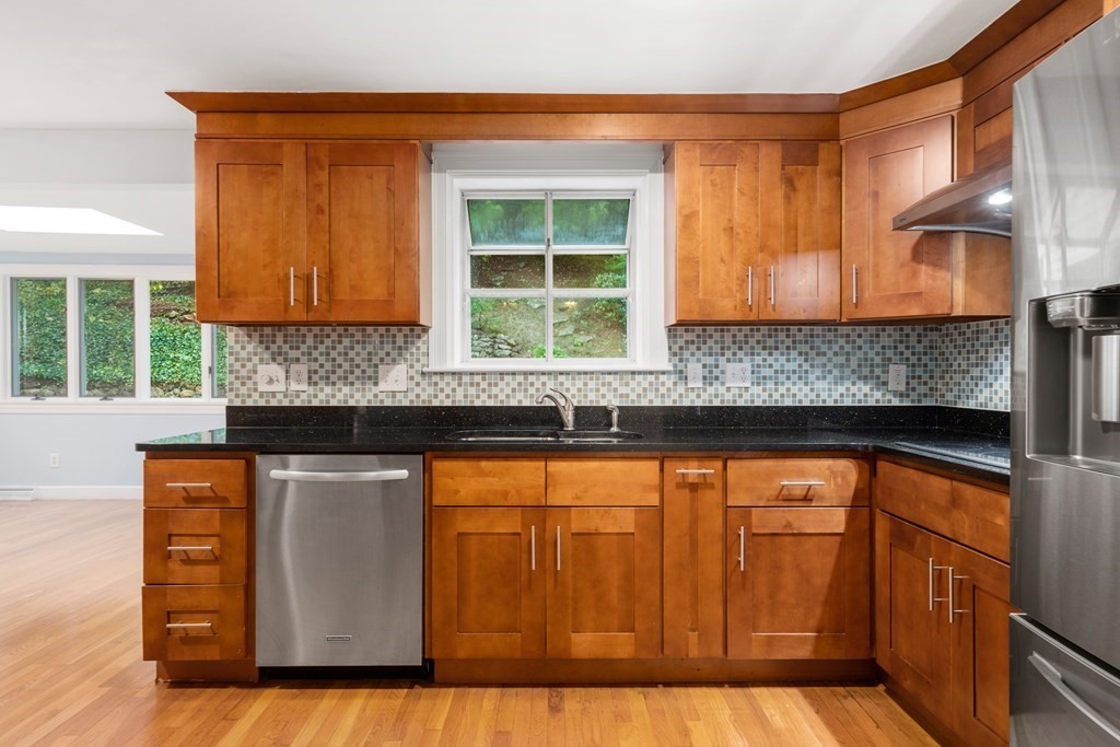 45 Wareland Road Wellesley, MA 02481 - Photo 8 of 26 a kitchen with granite countertop wooden cabinets a granite counter tops and a large window