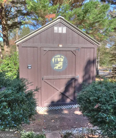 a living room with furniture and view of kitchen