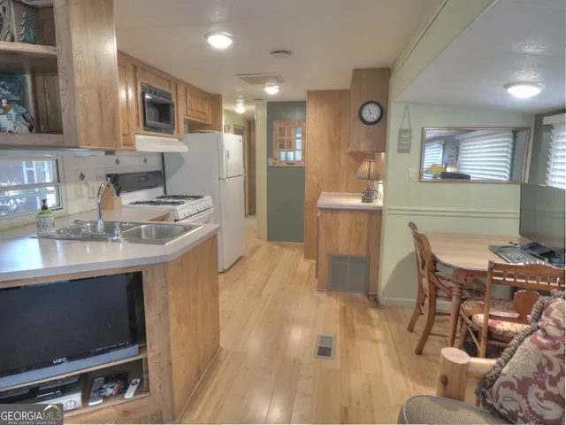 a kitchen with a refrigerator sink and stove