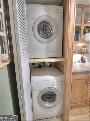a bathroom with a granite countertop sink mirror and shower