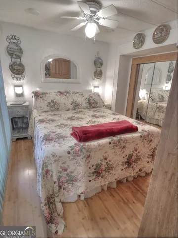 a bedroom with a bed and wooden floor