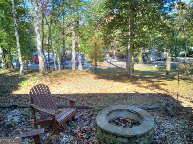 a backyard of a house with large trees and brick walls