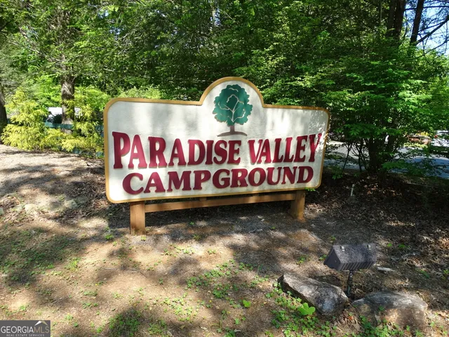 a view of a house with swimming pool and sitting area
