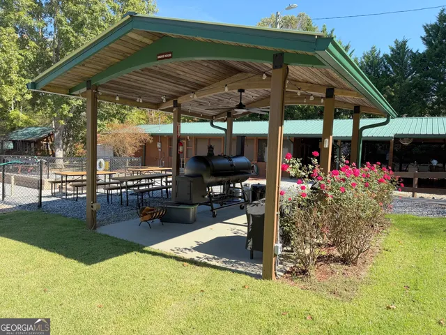 a view of a patio with a table and chairs