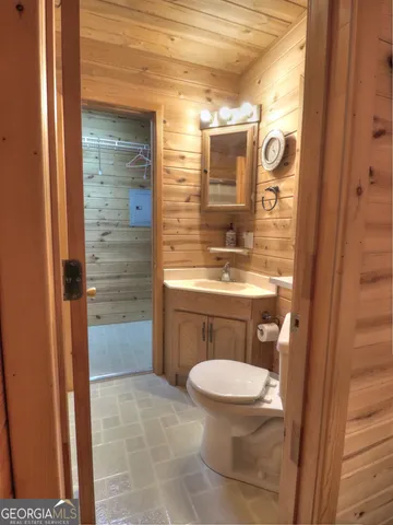 a bathroom with a toilet a sink and shower