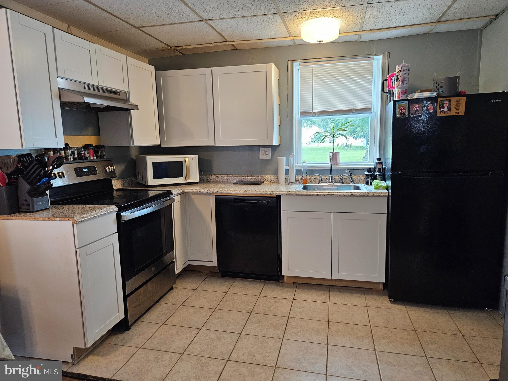 116 Maple Avenue Preston, MD 21655 - Photo 2 of 5 a kitchen with a sink a stove and cabinets