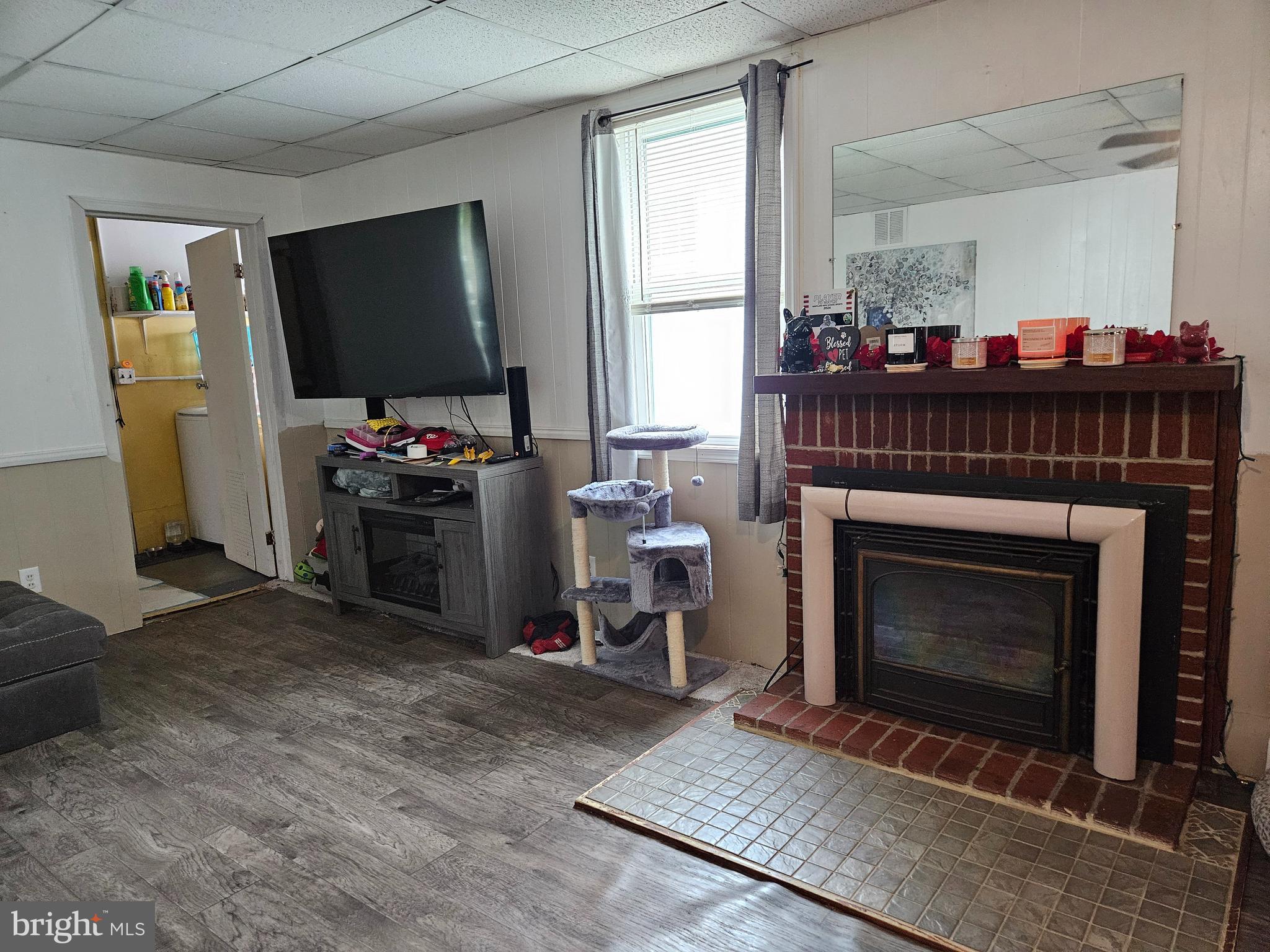 116 Maple Avenue Preston, MD 21655 - Photo 4 of 5 a living room with furniture a flat screen tv and a fireplace
