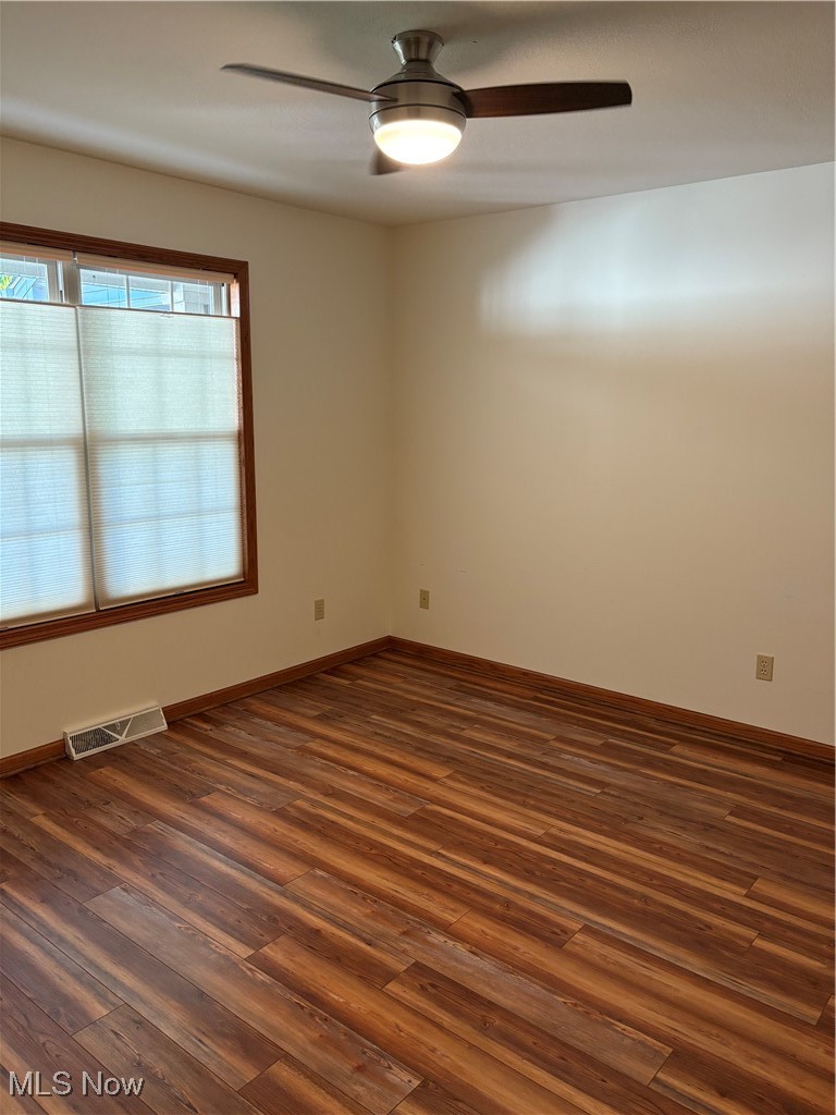 6695 Clingan Road, Unit 24 Youngstown, OH 44514 - Photo 16 of 26 Empty room featuring dark wood-style flooring and a ceiling fan