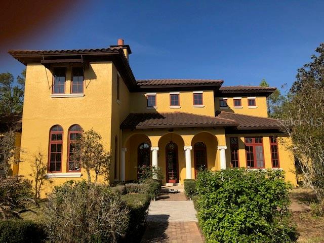 897 Spring Park Loop Celebration, FL 34747 - Photo 1 of 1 a front view of a house with a garden