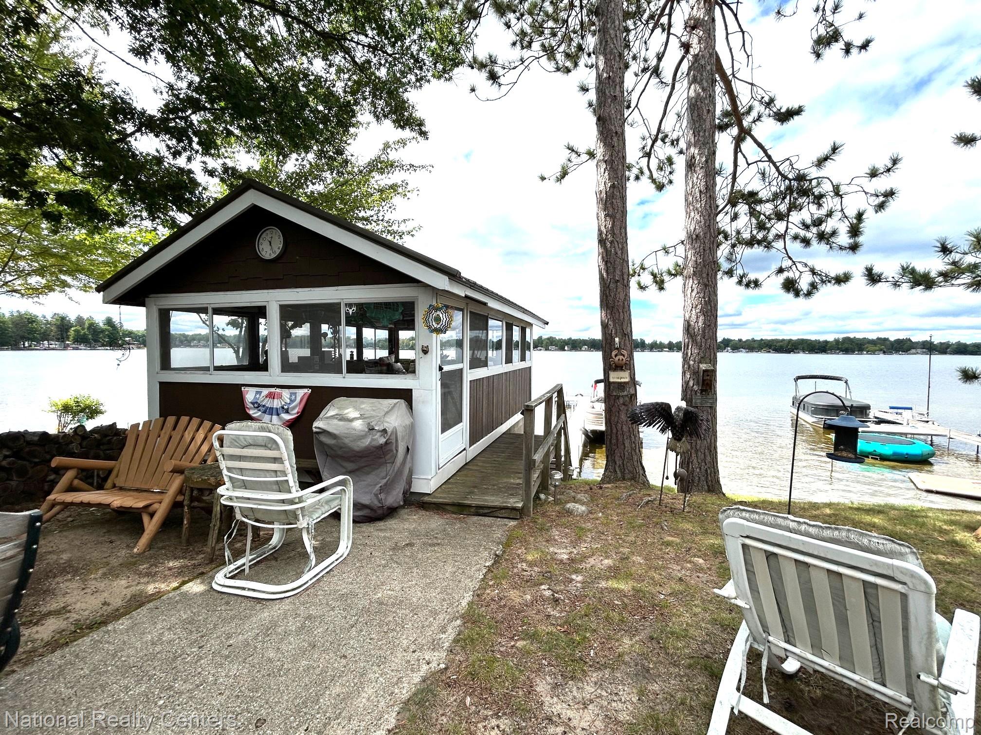 4951 Kokosing Road Hale, MI 48739 - Photo 18 of 37 Dock with a water view and a sunroom