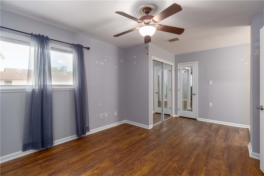6232 Weber Road Corpus Christi, TX 78413 - Photo 15 of 23 a view of an empty room with wooden floor and a window