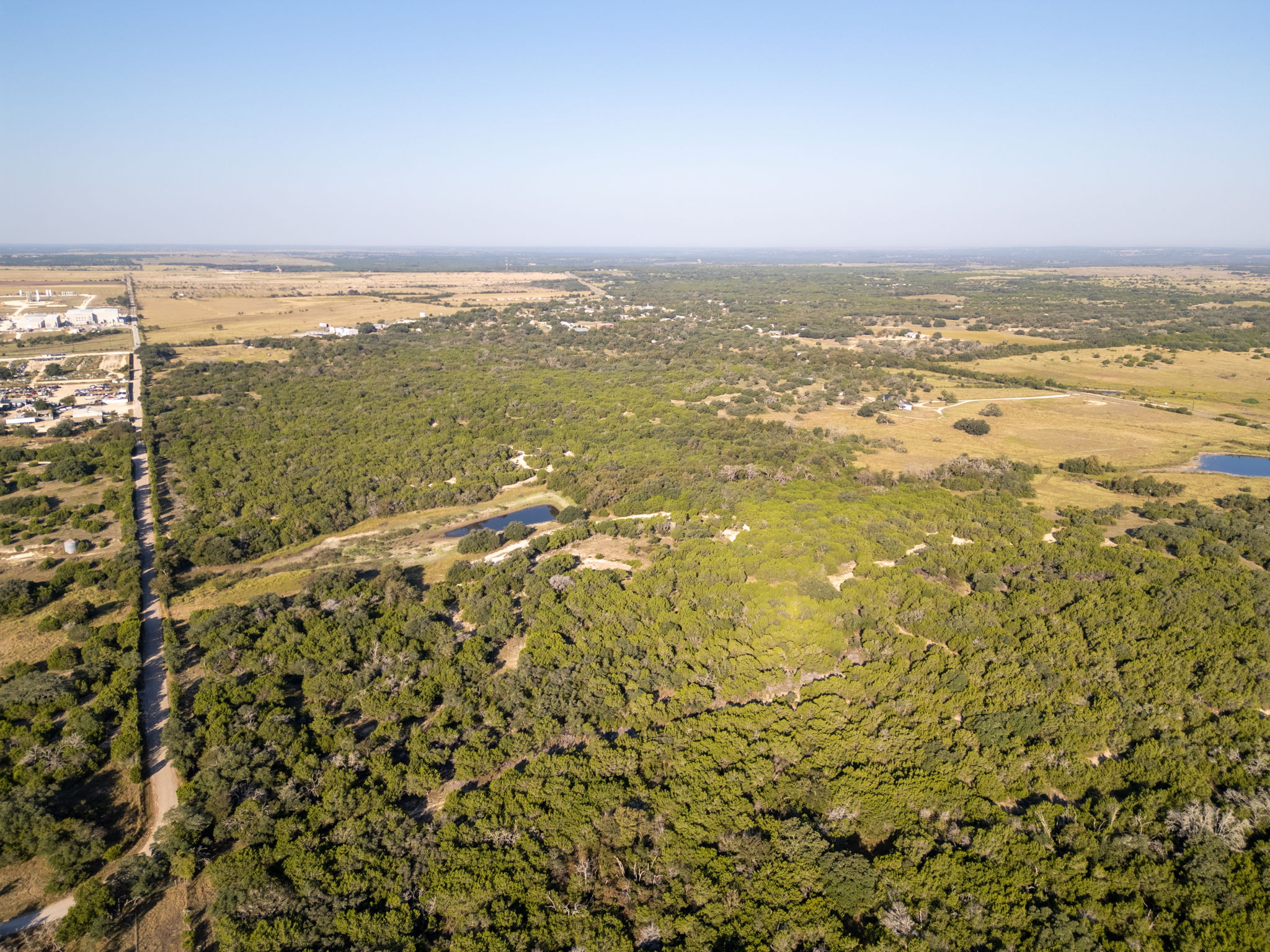 112 Loop 308 Briggs, TX 78608 - Photo 11 of 37 Aerial view of property's location with a forest