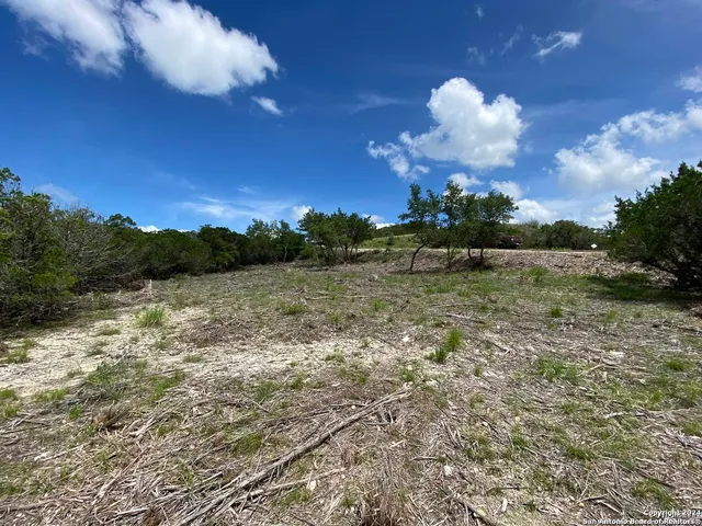 a view of a lake with houses in the background